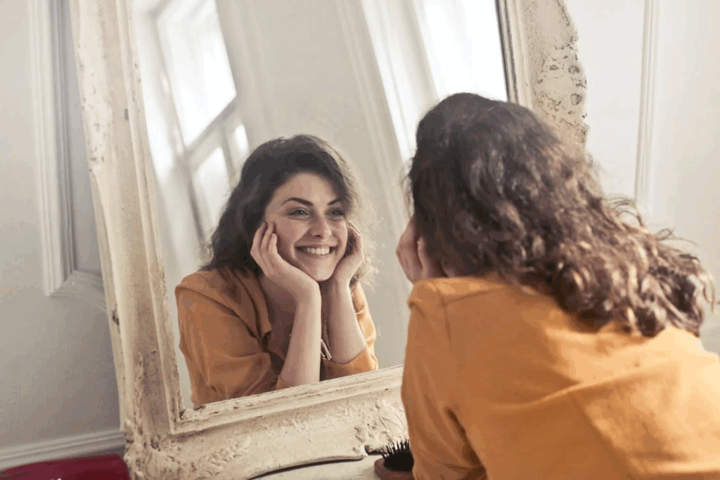 image of a woman looking at her teeth infornt of a mirror