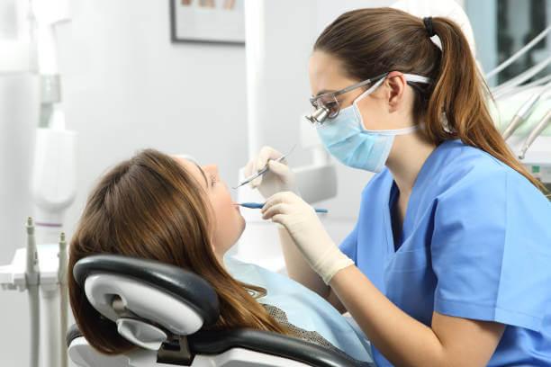 a patient undergoing a dental cleaning at the dentist’s office.