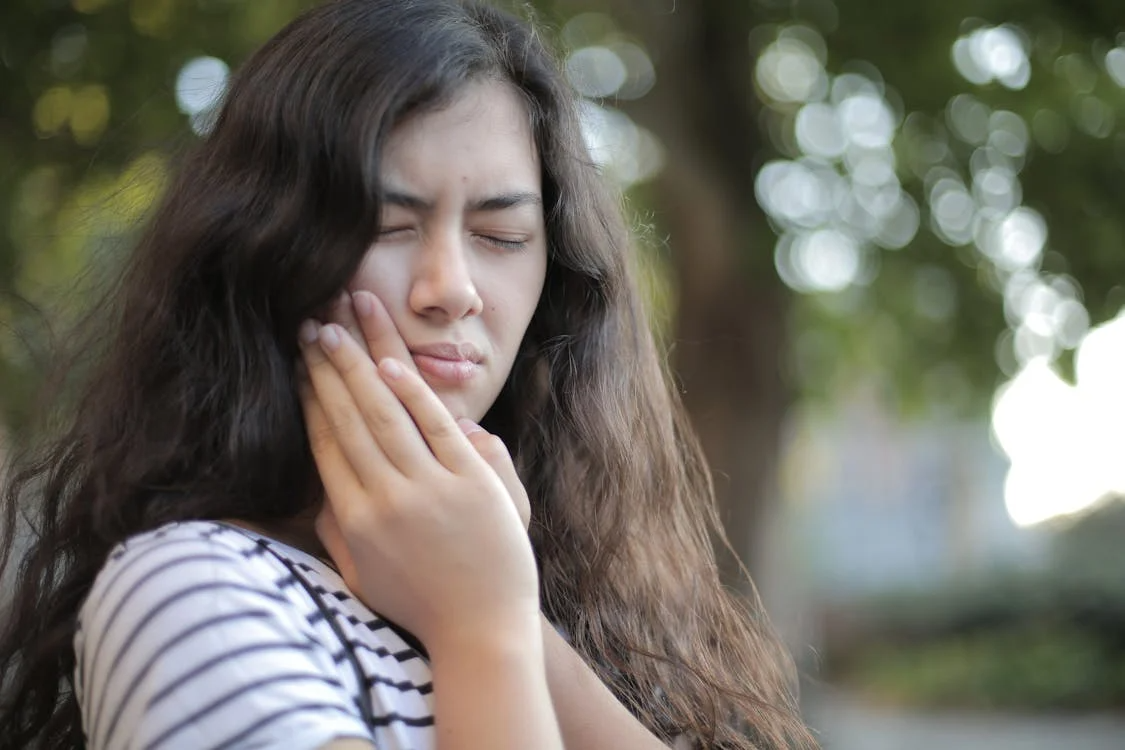 a woman experiencing tooth pain